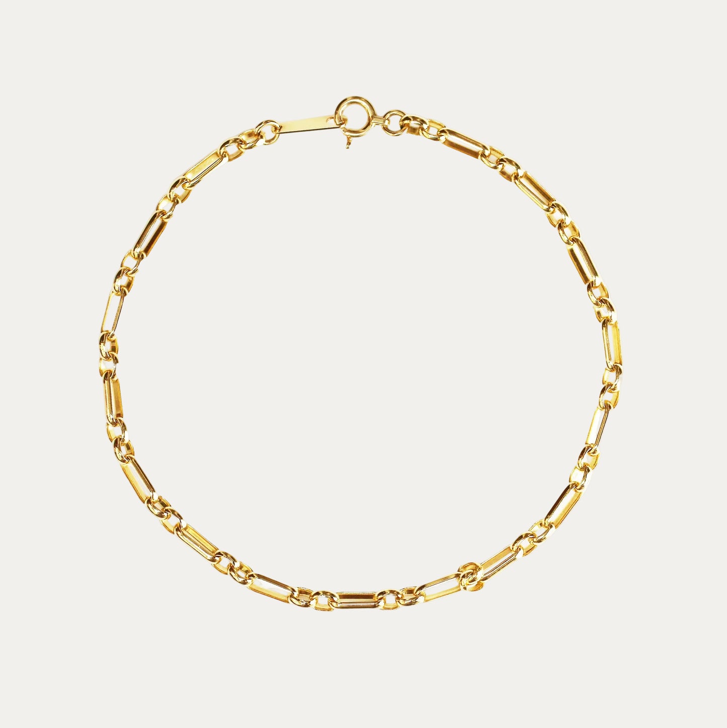 Gold chain bracelet on a white background