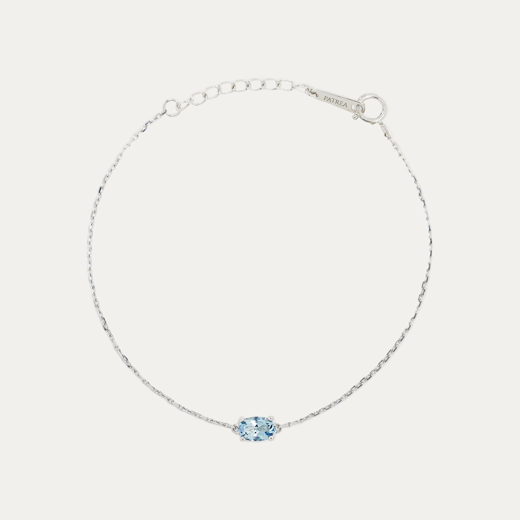 18k White Gold bracelet with an ocean blue aquamarine on a light gray background