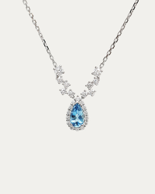 18k white gold Necklace with accent diamonds and santa maria aquamarine pendant on a light beige background