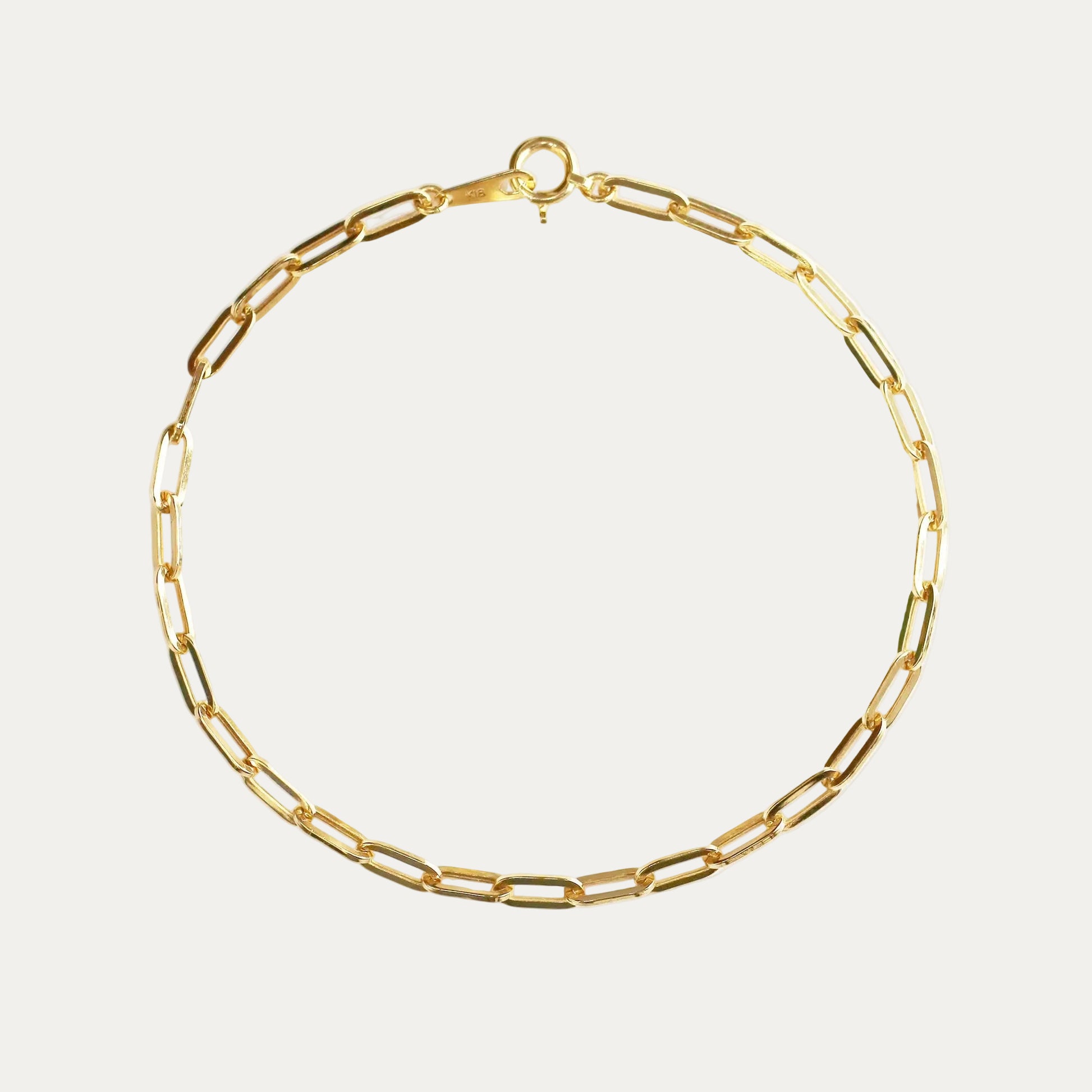 Gold chain bracelet on a white background