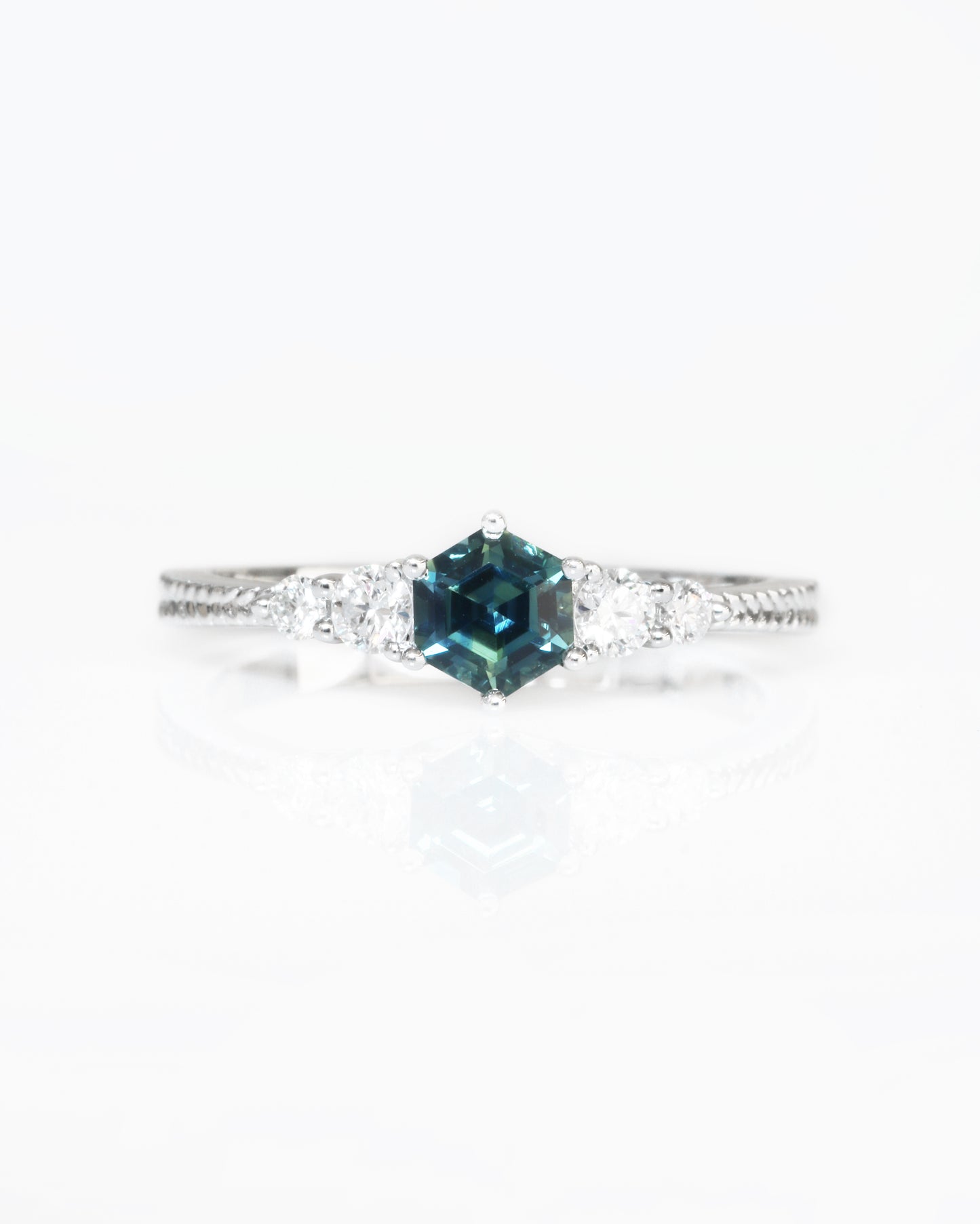 18k white gold blue green teal sapphire ring on a white background