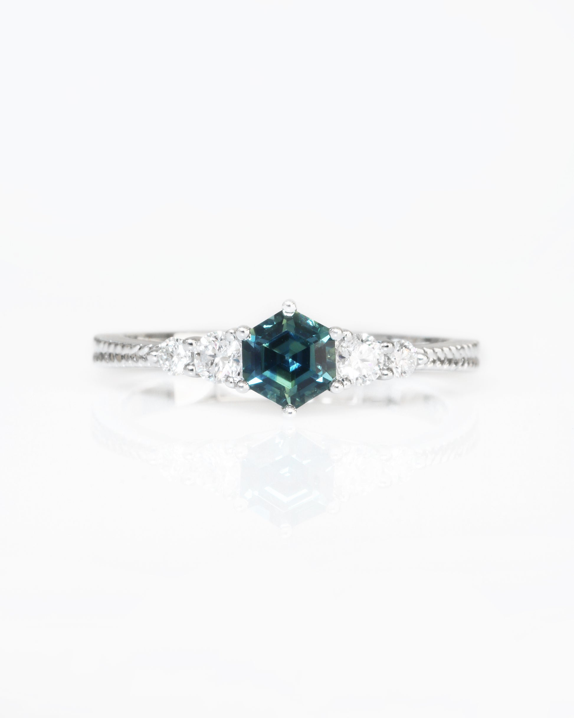 18k white gold blue green teal sapphire ring on a white background
