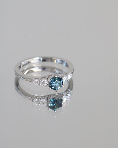 18k white gold blue green teal sapphire ring on a gray background